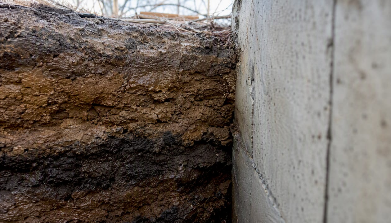 Soil layers pressing foundation wall inward